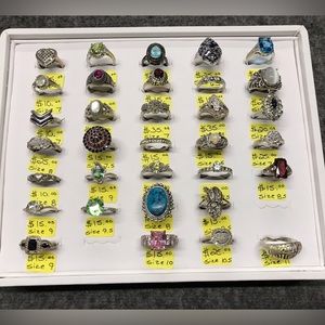 Various silver rings .